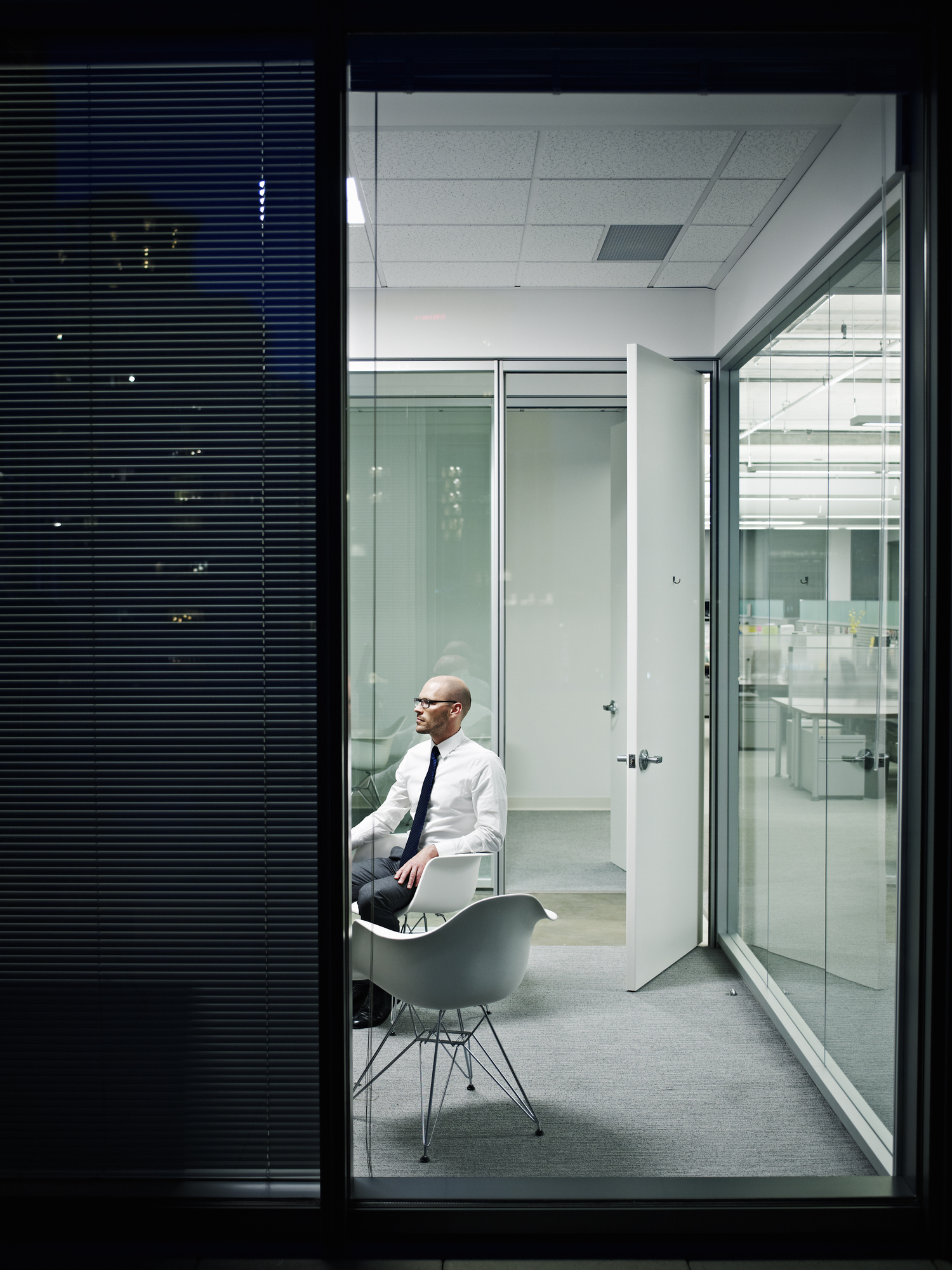 Businessman in empty office at night